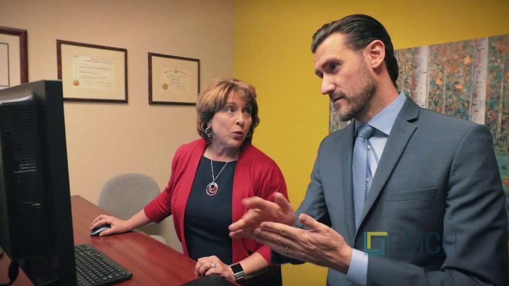 Two employees talking at PMCH Accounting Firm
